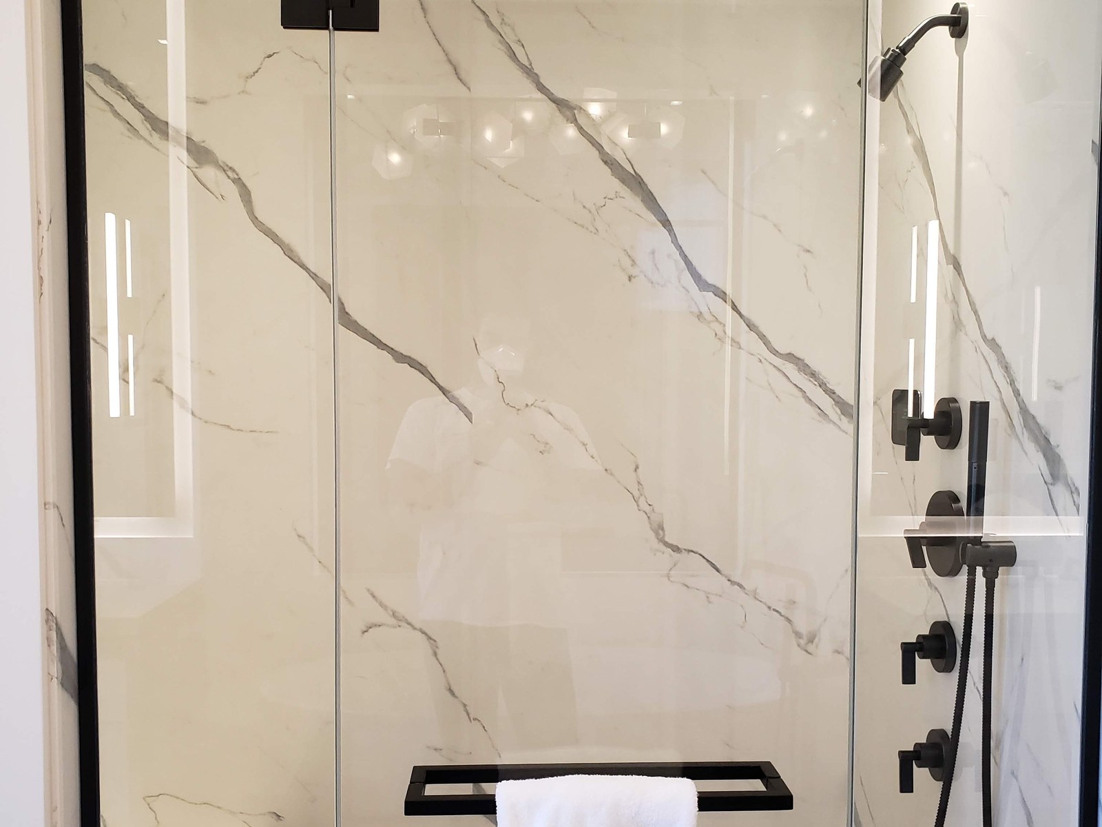 Integrated lighting in a marble shower in Hampstead