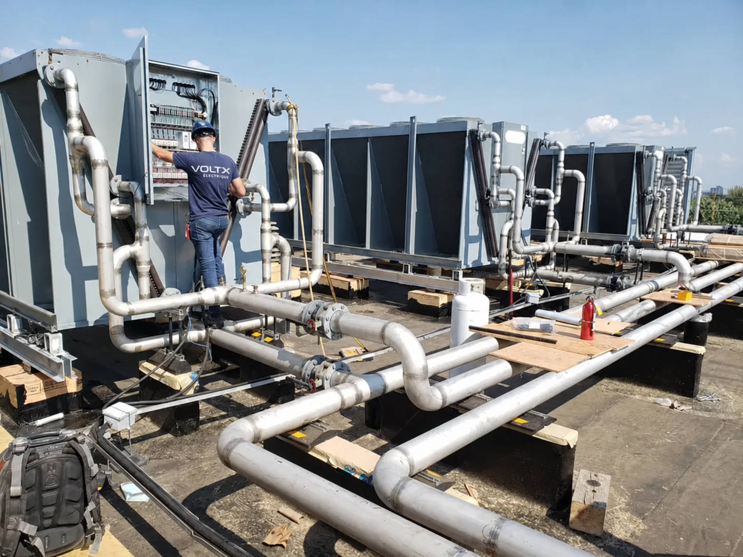 VoltX electrician working on a commercial rooftop mechanical system